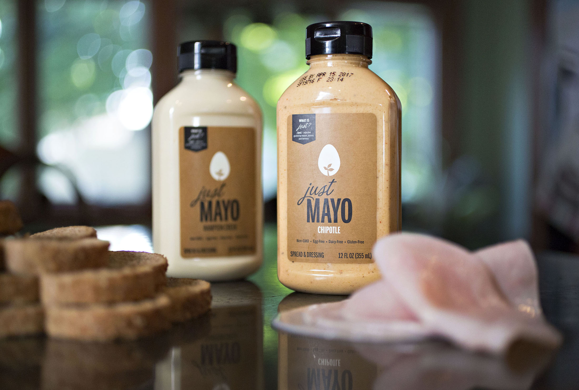 Jars of Hampton Creek Inc. Just Mayo brand egg-less mayonnaise are arranged with deli meat and bread for a photograph in Tiskilwa, Illinois, U.S., on Tuesday, Aug. 16, 2016. The U.S. Securities and Exchange Commission is looking into whether the San Francisco-based food technology startup, Hampton Creek, broke the law by not disclosing that it was buying its own vegan mayonnaise from stores, which made the product appear to be more successful than it was, according to people familiar with the matter. Photographer: Daniel Acker/Bloomberg